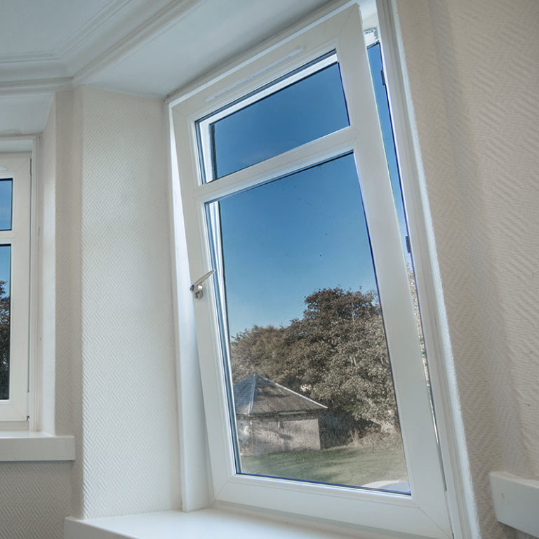A PVCu tilt and turn window with view onto the garden