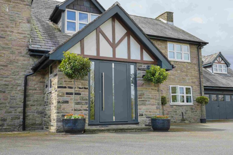 rural property with dark grey aluminium front door - Associated Windows